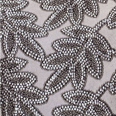 Tissu en polyester mélangé fond taupe et motif relief anthracite et gris clair